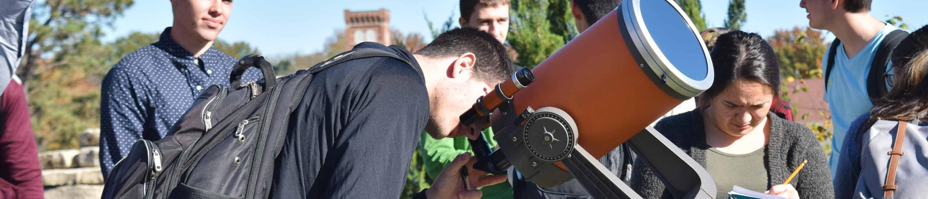 Students working with a telescope in Astronomy class